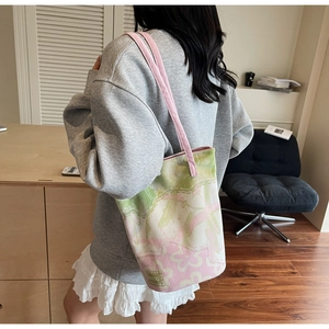 Detail of pink floral canvas tote bag showing thick jacquard texture and pink ribbon handle
