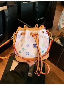 Mini drawstring bucket bag with colorful alphabet monogram print and red leather edges