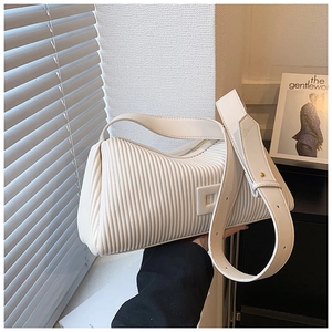 Detailed close-up of white pleated texture and premium faux leather on the stylish bag