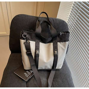 Close-up of contrast color tote bag with wide strap on a velvet chair interior