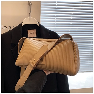 Detail of apricot vertical pleat texture on stylish leather cylinder crossbody bag