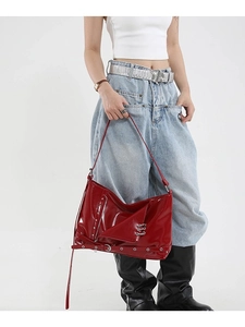 Red patent leather tote with silver studs and metal ring accents for a punk y2k style