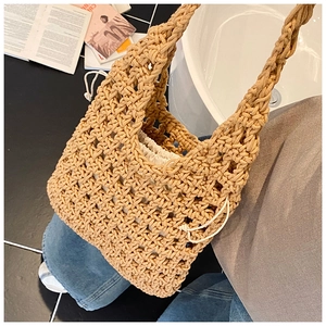 Close-up of khaki woven hollow tote bag with a white drawstring inner pouch for women