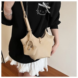 Detail of beige bucket bag set with wavy edge design and matching mini pouch accessory
