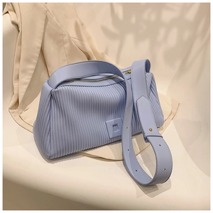 Close-up of light blue pleated leather texture and rectangular pillow bag design