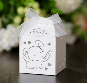 Detailed laser-cut elephant pattern on white pearlescent wedding favor box with ribbon