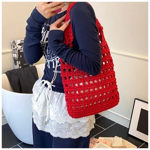 Detailed view of red crochet tote bag featuring oversized hollow knit mesh pattern