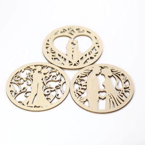 Detailed laser-cut heart and couple silhouette designs on natural wooden wedding coasters