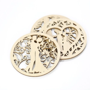 Laser-cut wooden wedding coasters featuring a romantic kissing couple silhouette