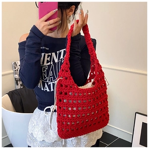Close-up of red hollow knit tote bag with a white drawstring inner pouch for privacy