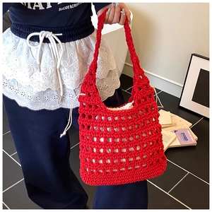 Detail of red hollow knit tote bag featuring a white drawstring inner pouch for security