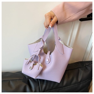 Close-up of lavender bucket bag with lychee grain texture and matching mini pouch charm