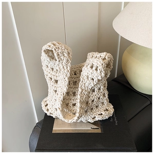 Detailed macro view of the cream white handmade crochet hollow knit tote bag texture
