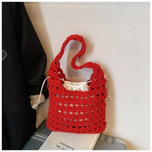 Detail of red hollow knit tote bag featuring a white drawstring inner pouch and mesh texture