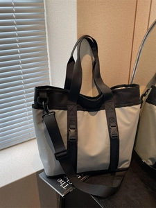 Large capacity grey nylon tote bag with black straps and adjustable shoulder padding
