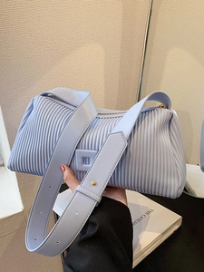 Light blue pleated dumpling bag with wide shoulder strap and gold hardware accents