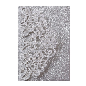 Detailed laser-cut silver glitter wedding invitation with intricate lace petal texture