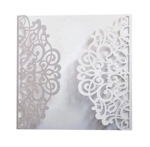 Detailed laser-cut vine patterns on white pearlescent paper for wedding invitations