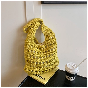 Detail view of yellow crochet tote bag with hollow grid texture and drawstring lining
