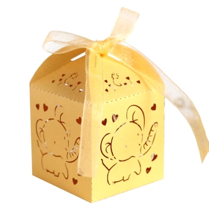 Detailed laser-cut elephant and heart patterns on light yellow wedding favor box