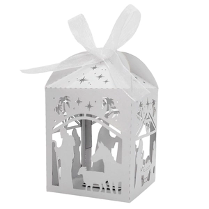 White laser-cut candy box featuring a nativity scene with an elegant white organza bow