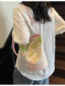 Floral canvas bucket bag with pink shoulder strap and stylish abstract flower pattern
