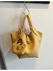Fashionable yellow leather bucket bag set with litchi texture and matching mini pouch charm