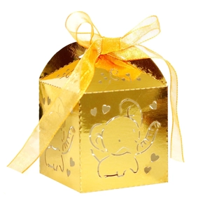 Detailed laser-cut gold candy box with elephant and heart motifs and yellow ribbon