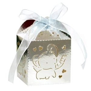 Detail of silver laser-cut elephant candy box with blue chiffon ribbon and heart pattern