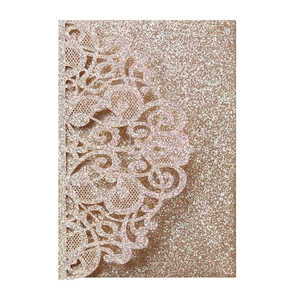 Detail of rose gold glitter laser-cut invitation card with vintage lace pattern