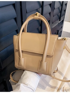 Minimalist beige PU leather crossbody bag with dual top handles and adjustable strap