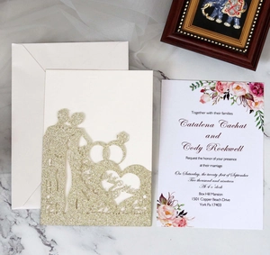Macro shot of glitter laser cut wedding invitation with Mr & Mrs heart pattern