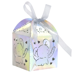 Macro detail of laser-cut elephant and heart patterns on iridescent gift box