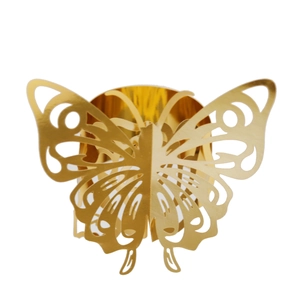 Detail of laser-cut butterfly napkin ring in golden mirror finish for table decor