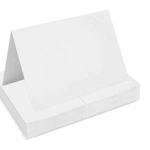 Stack of white folded place cards for weddings and office events on a clean white background