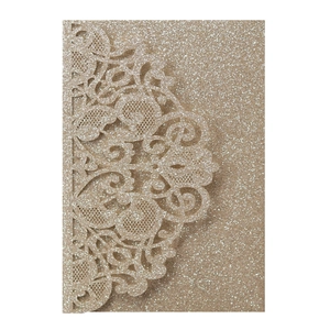 Detailed laser-cut champagne gold wedding invitation with sparkling glitter finish
