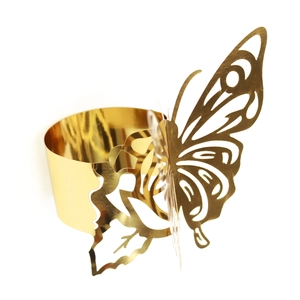 Detailed close-up of a golden laser-cut butterfly napkin ring with mirror finish texture
