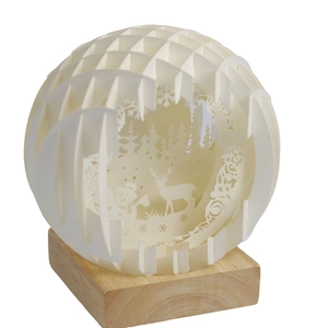 3D paper-cut globe lamp with winter forest scenery and wooden base for Christmas