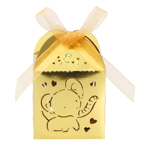 Detail of hollow elephant and heart pattern on golden gift box with ribbon bow
