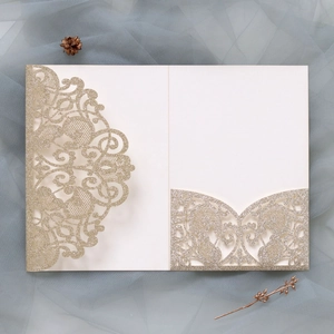 Macro view of champagne gold glitter laser cut lace wedding invitation pocket