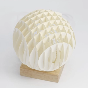 Detailed view of honeycomb hollow paper-cut ball lamp with natural solid wood base