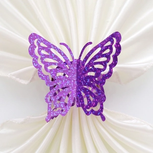 Laser-cut 3D butterfly napkin ring with purple glitter finish on white satin