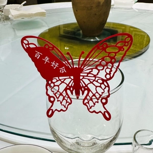 Detail of red butterfly paper glass card with laser cut pattern for wedding banquet