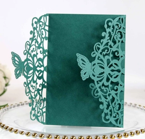 Detail of laser-cut dark green wedding invitation with elegant butterfly hollow design