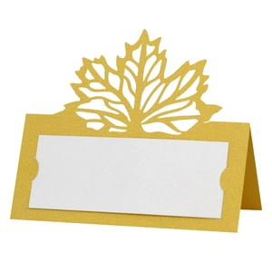 Detailed view of laser-cut gold maple leaf place cards with pearlescent finish