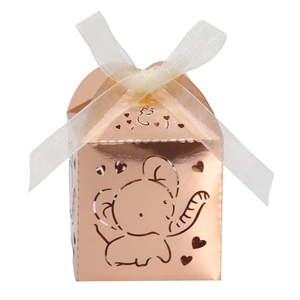 Detail of rose gold mirror candy box with hollow elephant and heart patterns and ribbon