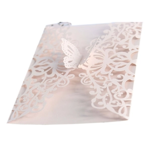 Detail view of pink laser-cut wedding invitation cover with a 3D butterfly design