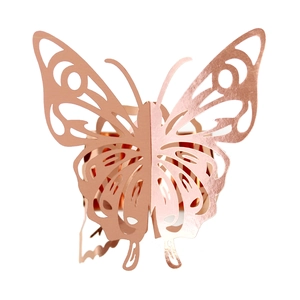 Detailed view of hollow rose gold butterfly napkin ring with laser-cut floral patterns