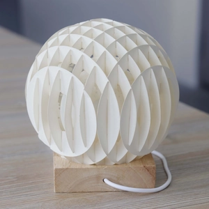 Modern geometric sphere paper cut lamp with snowman design and natural wood base