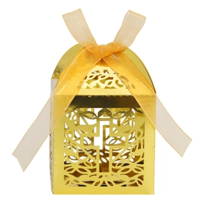 Detail of golden hollow cross gift box with laser-cut vine patterns and silk ribbon